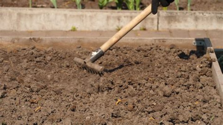 How do you turn soil over by hand?